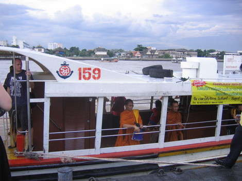 Taking the boat on the Chao Praya River often involves monks