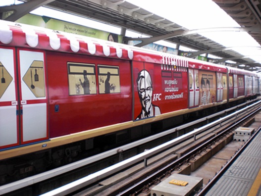 Bangkok's BTS skytrain system makes tens of millions of baht every year from selling advertising on its trains -- this one is slathered with a train-length ad for KFC.