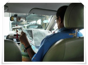 taxi driver reading newspaper