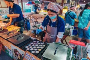 food stall seller with mask thailand